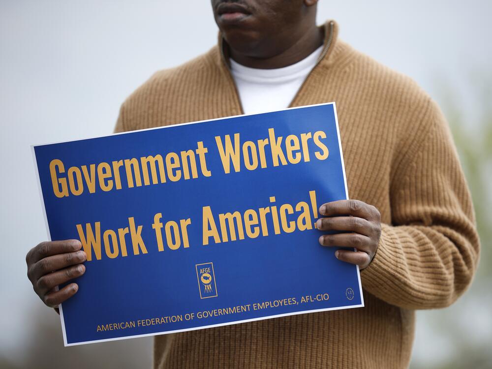 A union supporter holds a sign at a press conference on federal workforce rights outside the U.S. Capitol on March 28, 2025 in Washington, D.C.