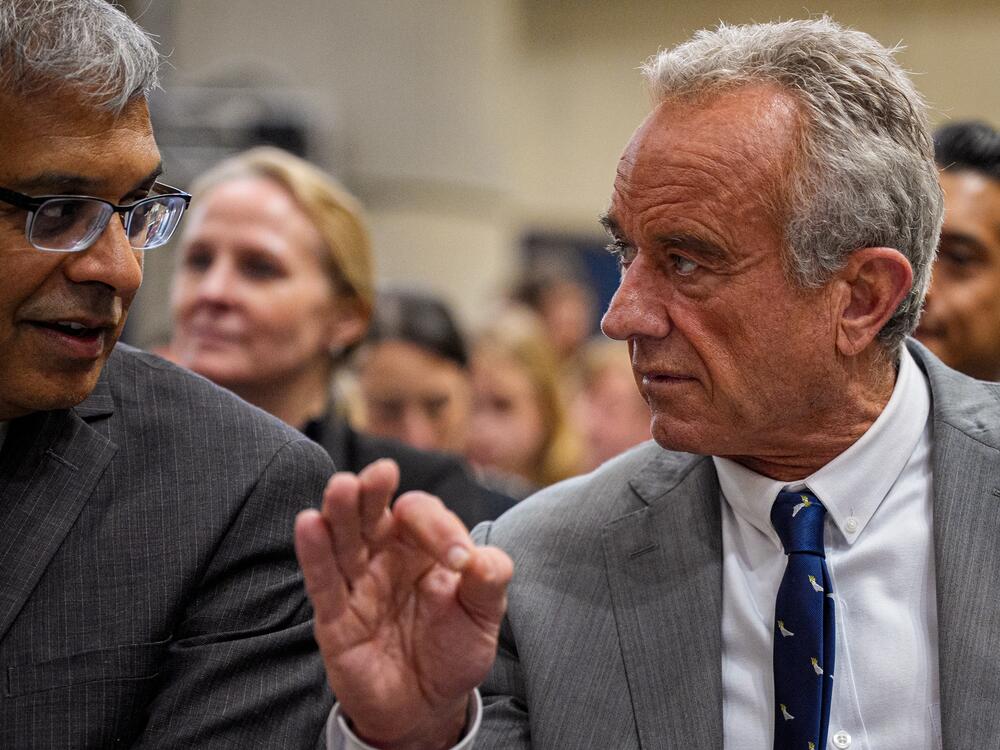 NIH Director Jayanta Bhattacharya, left, and Health and Human Services Secretary Robert F. Kennedy Jr. speak before a news conference at the Health and Human Services Department on April 22.
