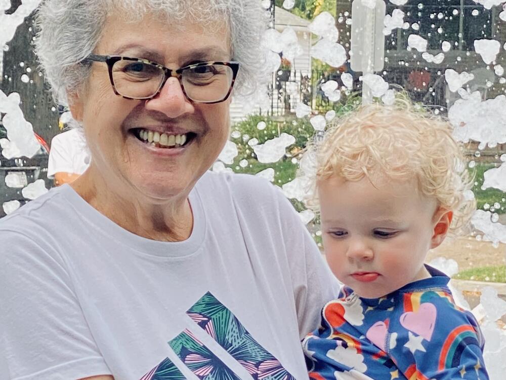 Michael Sweet's mother, Donna Sweet, holds her 18-month-old great-granddaughter, Margot Higgins, during a family event celebrating her wedding anniversary.