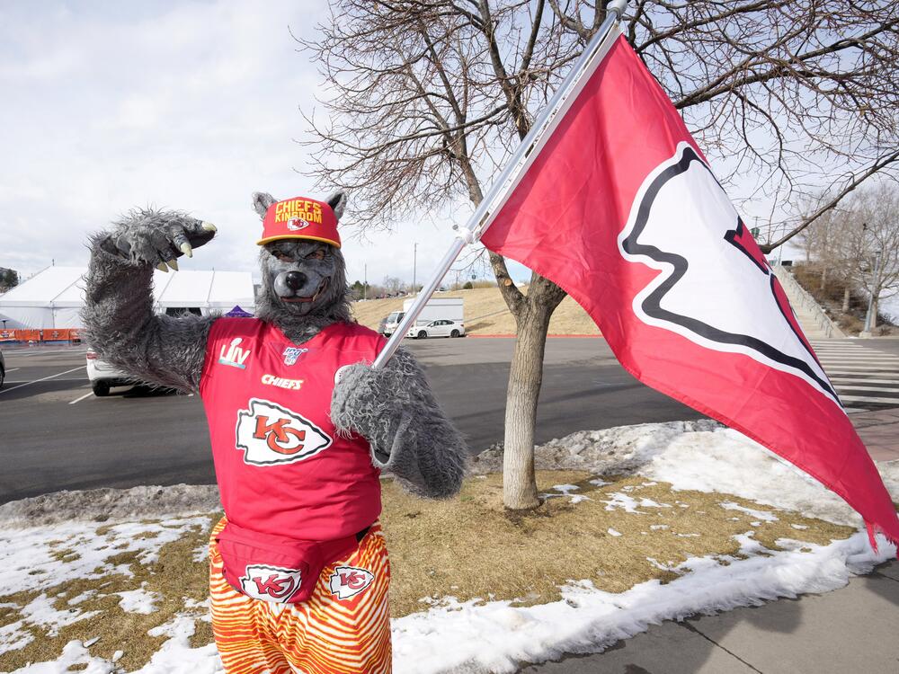 A Kansas City Chiefs fan, ChiefsAholic, poses for photos while walking toward Empower Field at Mile High before an NFL football game between the Denver Broncos and the Chiefs,on  Jan. 8, 2022, in Denver.