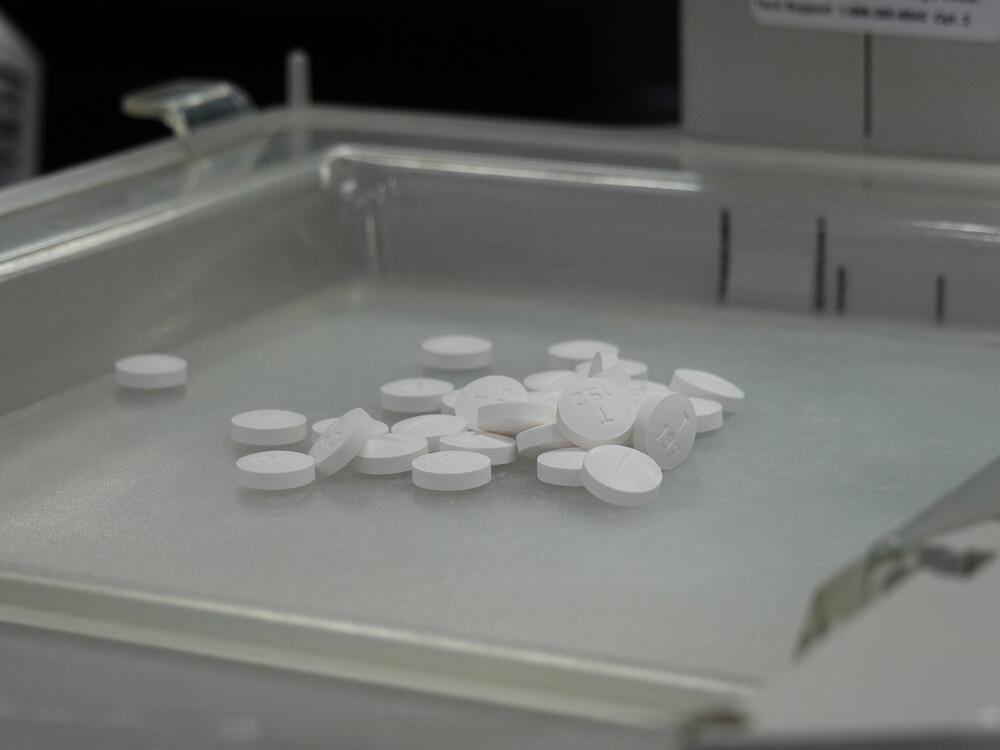 Pills sit in the tray of a pill-counting machine at 986 Pharmacy in Alhambra, Calif.