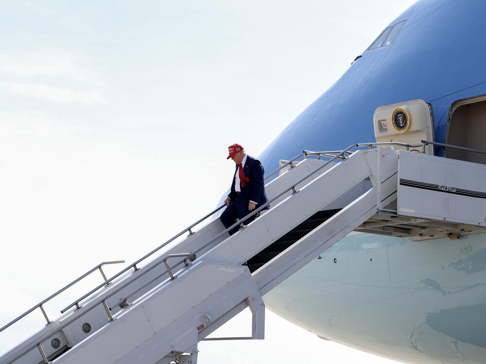 President Trump walks off Air Force One on April 29 at Selfridge Air National Guard Base, Michigan. Qatar has offered to replace Air Force One with a luxury Boeing 747 jet.