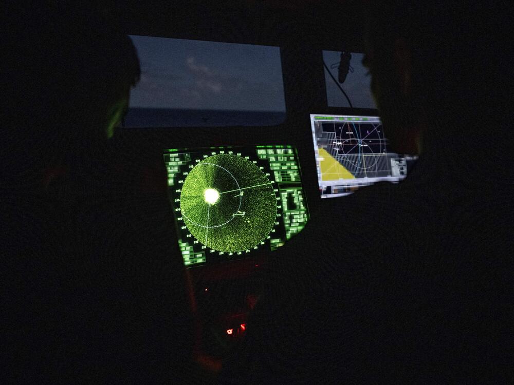 Members of the French Navy monitor radar in the control bridge in low light conditions during an anti-drug interception mission by the French surveillance frigate FS Ventose sailing off the French Caribbean island of Martinique, on November 16, 2024.