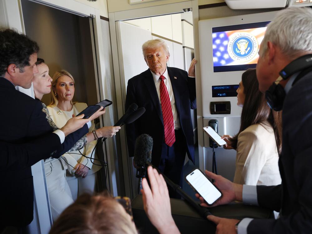 President Trump speaks to reporters on Air Force One about his meeting with Syria's interim president while flying to Doha, Qatar on May 14, 2025.