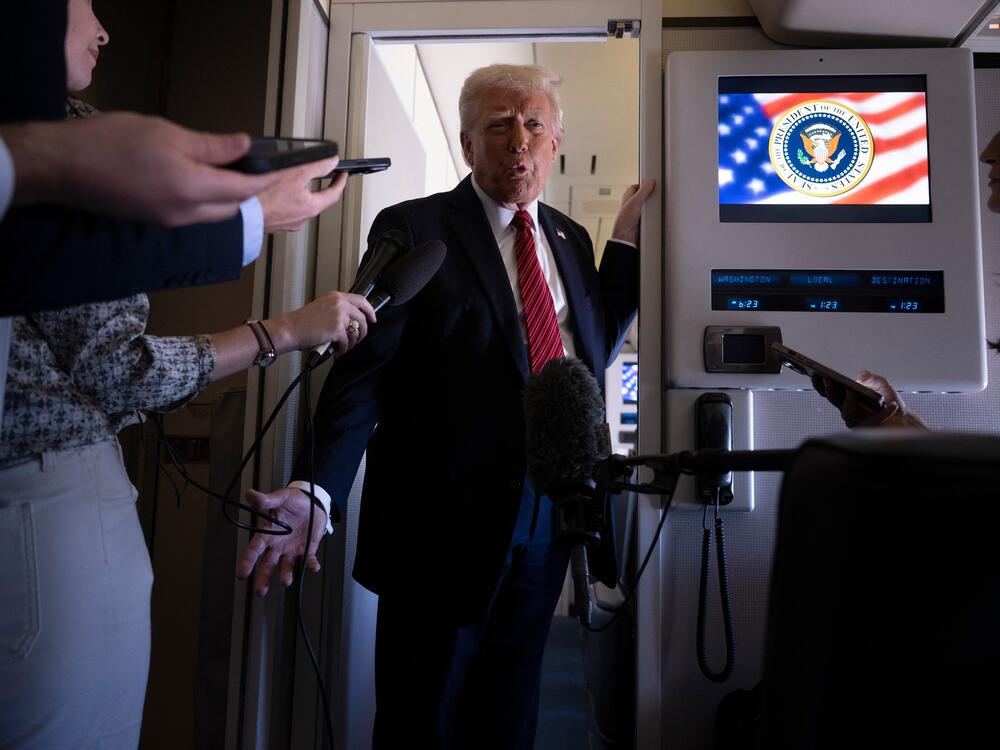 President Trump speaks to members of the press on Air Force One while flying over Saudi Arabia on his way to Qatar on Wednesday.