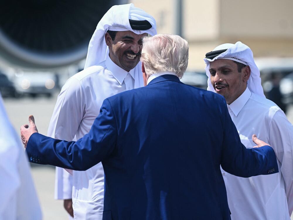 Qatar's Emir Sheikh Tamim bin Hamad al-Thani and Prime Minister Sheikh Mohammed bin Abdulrahman Al-Thani talk to President Donald Trump at the Al-Udeid air base on May 15, 2025.