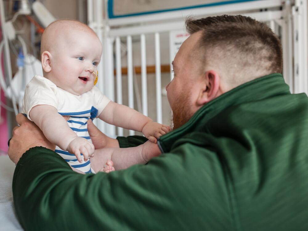 Kyle Muldoon plays with his son KJ after an infusion treatment.