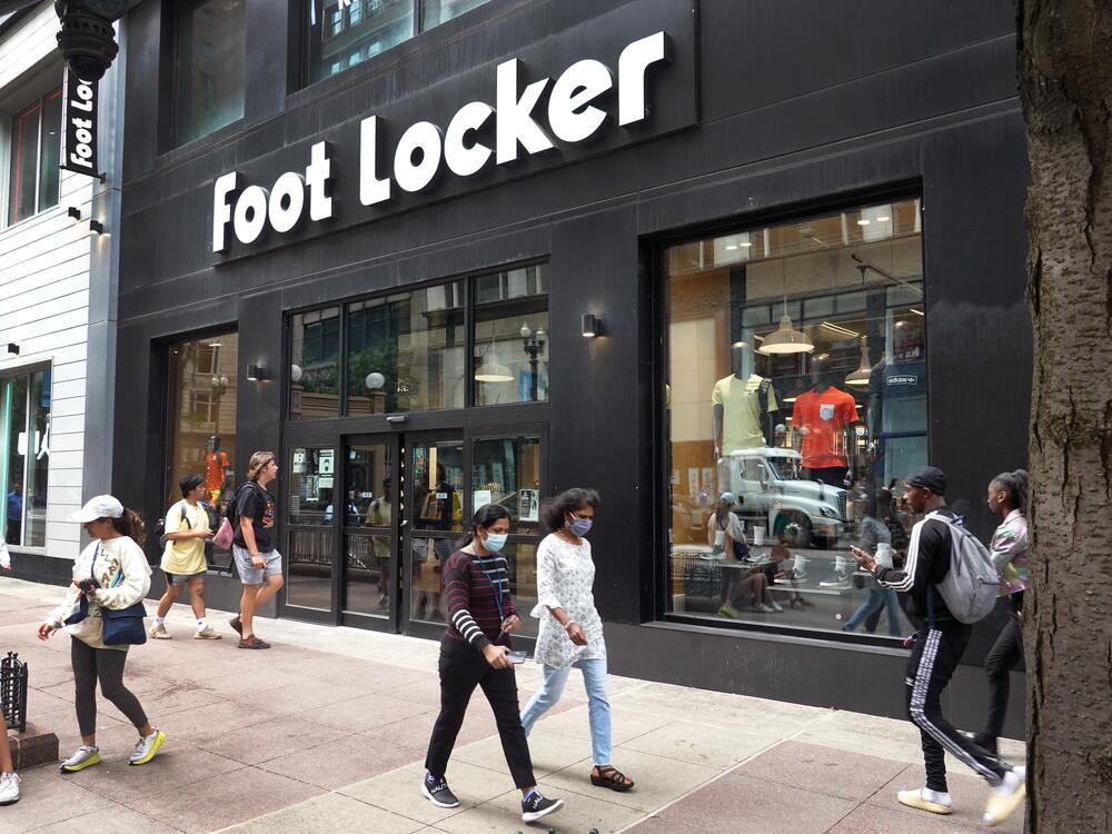 People walk by a Foot Locker store in Chicago.