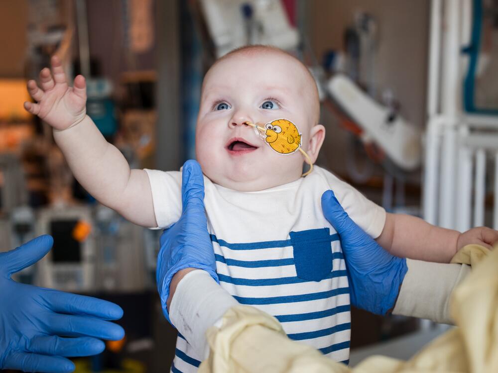 KJ Muldoon, who was born at Children's Hospital of Philadelphia in August, reaches out to doctors after being treated for a rare genetic disorder using CRISPR technology.