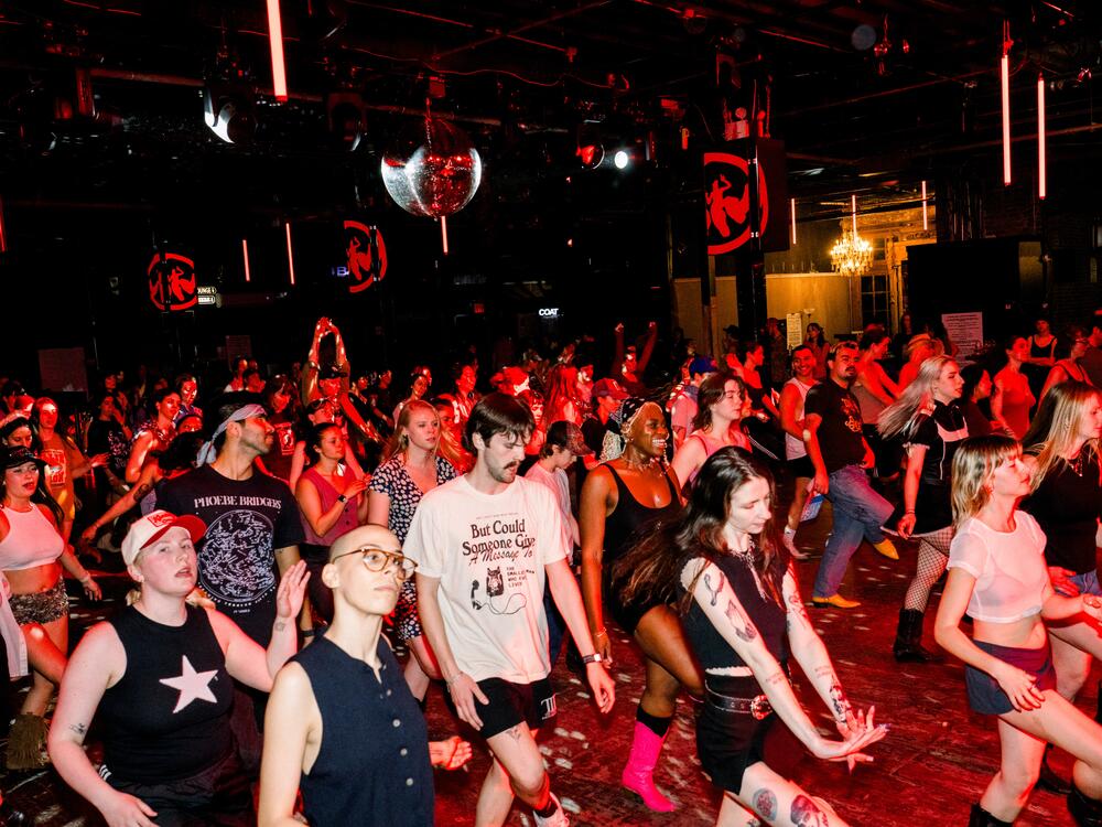 A crowd line dances at Stud Country in Brooklyn, N.Y., on March 25, 2025.