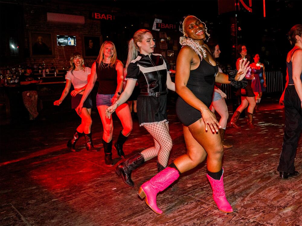 Top: From left: Karli Manship, Hannah Bruns, Jolie Elins and Kenya Jacobs line dance at Stud Country in Brooklyn, N.Y., on March 25, 2025. Bottom left:<strong> </strong>Stud Country attendees practice a partner dance step that was just taught in a lesson. Bottom right: People dance under the disco lights at Stud Country.<br>