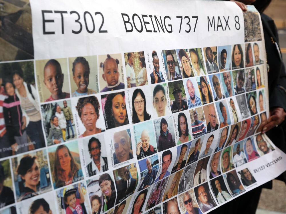 Relatives of victims hold a placard with photos of victims of the Ethiopian Airlines Flight 302 crash in March 2019, prior to a hearing in Fort Worth, Texas, in January 2023.