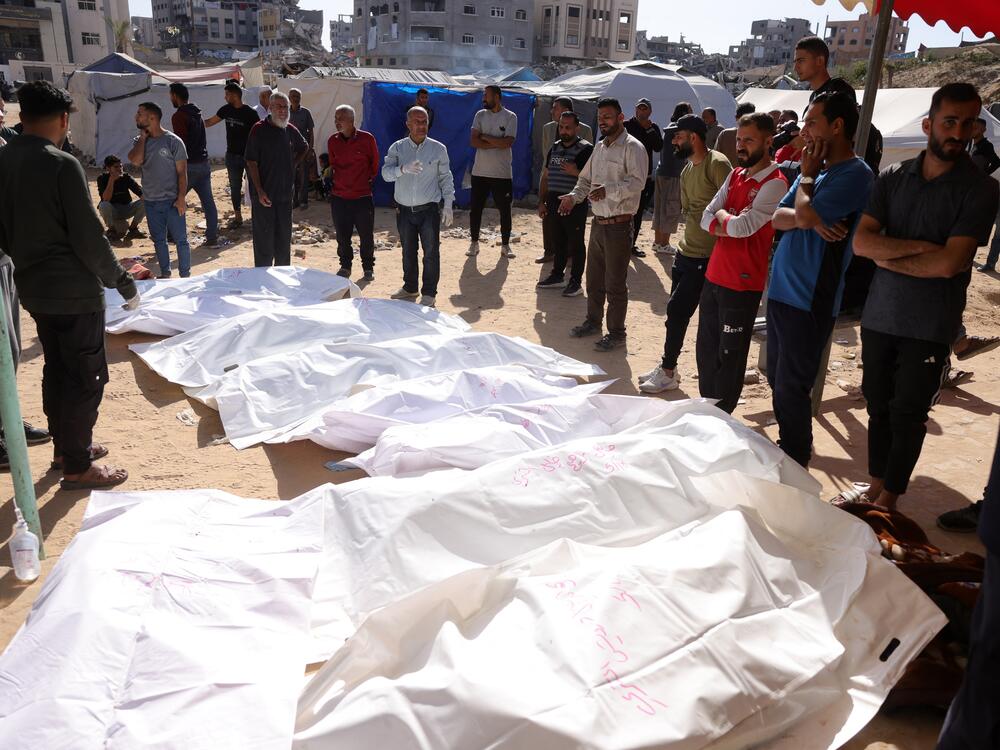 People surround the bodies of Palestinians killed in an Israeli strike in front of the Indonesian hospital in Beit Lahia in the northern Gaza Strip, on Friday.