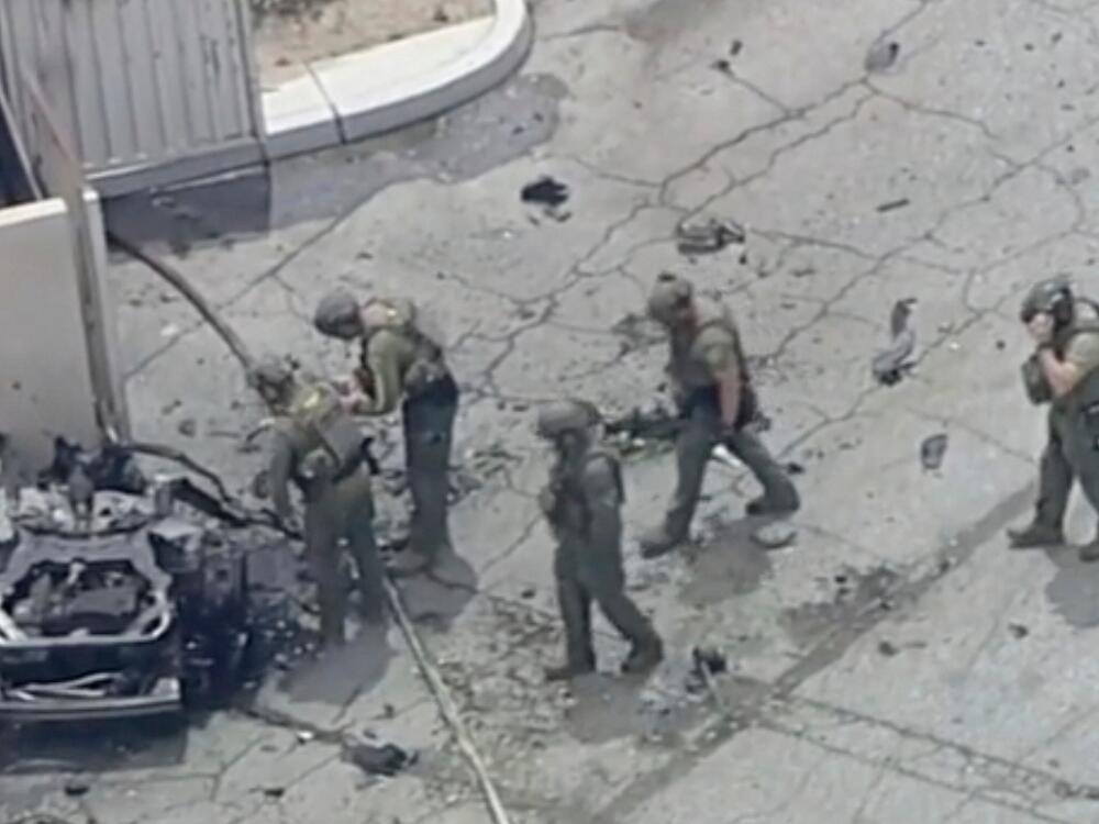 Law enforcement investigate a vehicle after an explosion on Saturday, May 17, 2025 in Palm Springs, Calif.