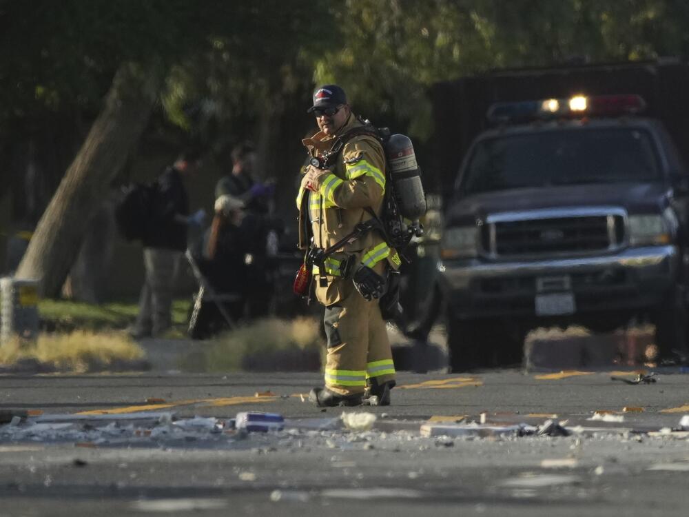 A firefighter stands at the scene of an explosion in Palm Springs, Calif., on Saturday.