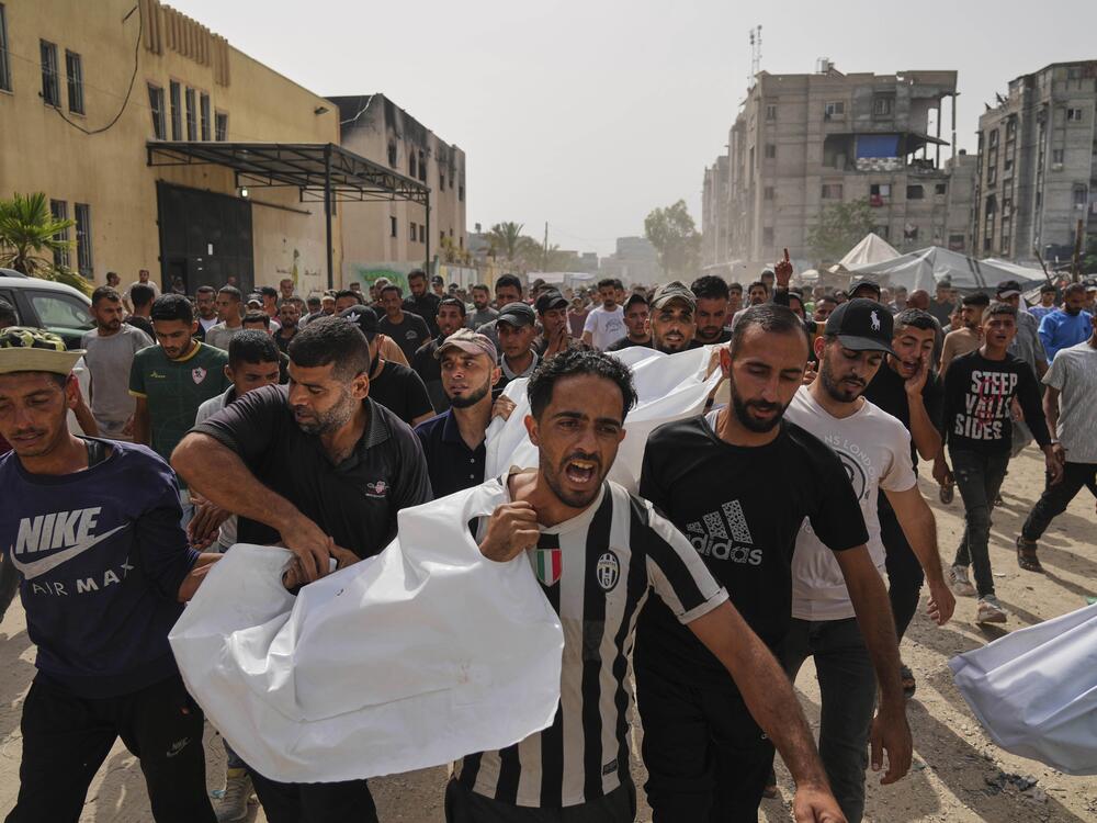 Palestinians carry the bodies of their relatives killed in an Israeli army airstrike, during their funeral in Khan Younis, Gaza Strip, Sunday, May 18, 2025.