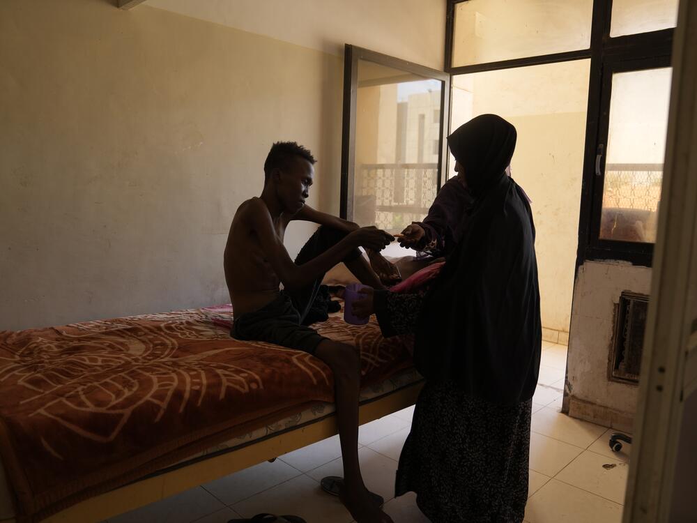 Wala'adin Abdurahaman, 22, photographed at a military hospital in Khartoum. The rebel RSF forces detained him for more than 18 months at Soba Prison in Khartoum. He said he was tortured constantly and given irregular and tiny quantities of food and water. Freed by the Sudanese army when they recaptured Khartoum, he had lost so much weight that when he reached his home, his mother initially refused to open the door as she didn't recognize her son.