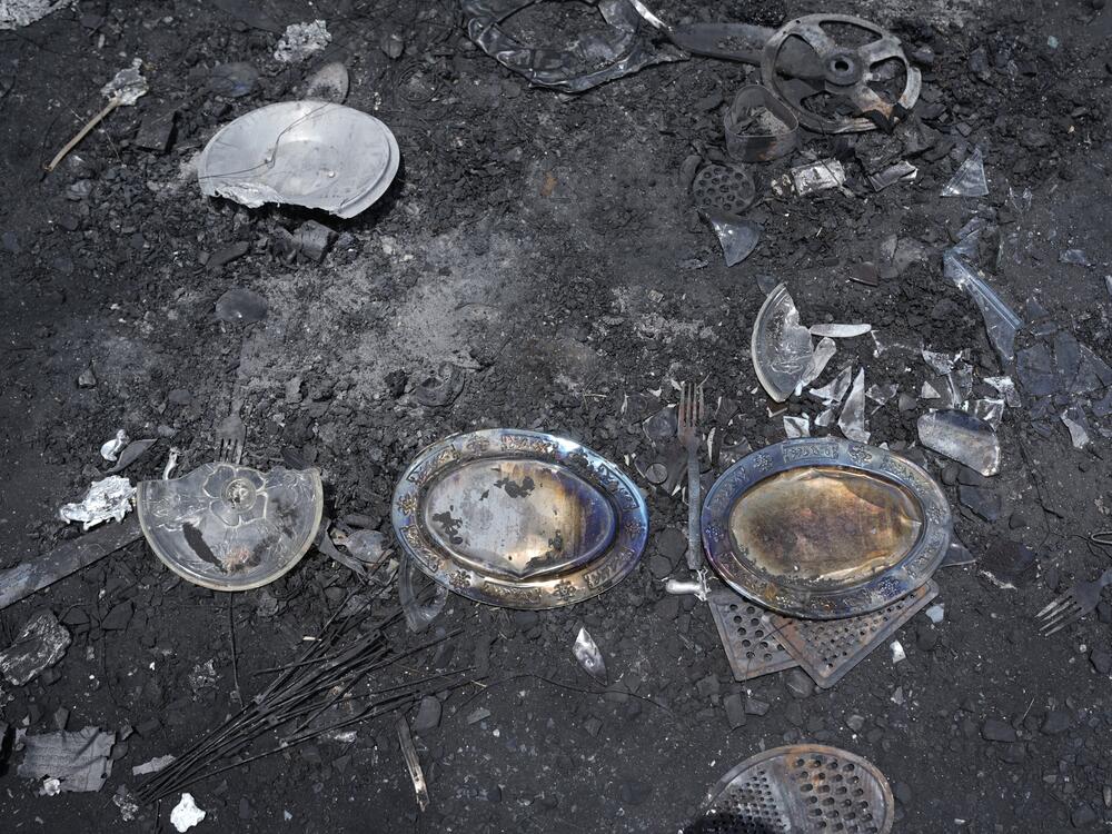 RSF fighters looted tons of goods and tried to take them out of Khartoum toward Western Sudan. But as the Sudanese army advanced, the fighters abandoned much of their loot — like these now burnt plates and cutlery.