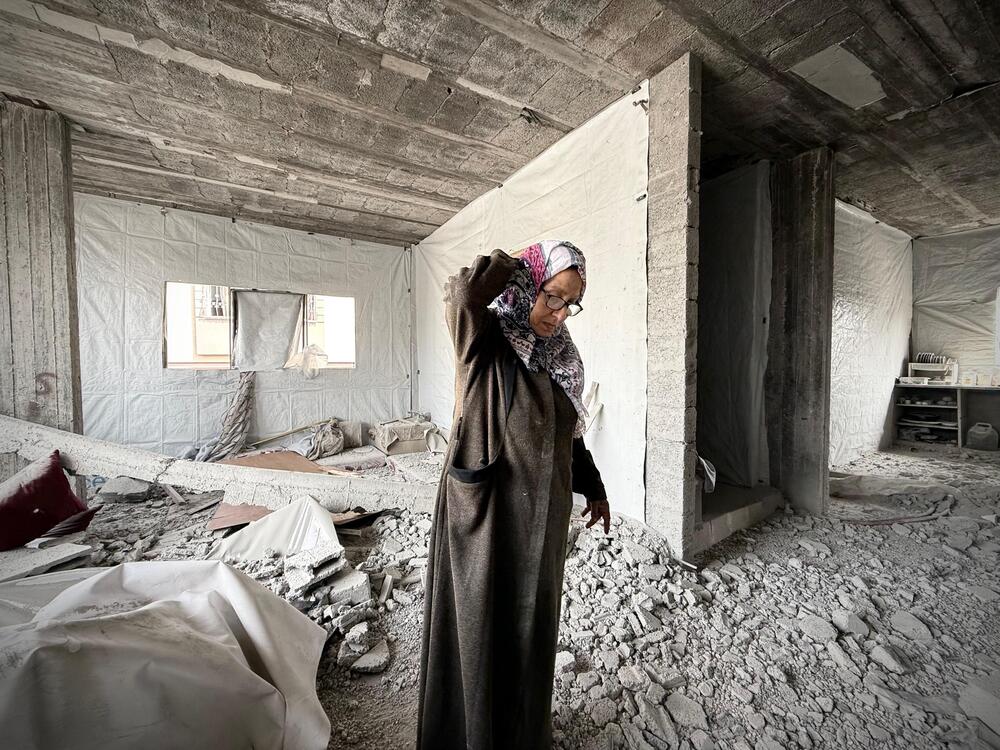Nadia Mukhaimar, 62, inspects the destruction of her house after an Israeli airstrike hit her neighbor's house, killing 20 Palestinians, according to Gaza health officials, in Jabalia, northern Gaza.