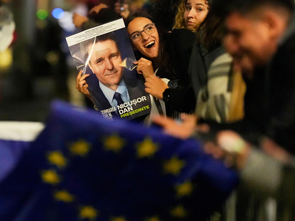 Supporters of presidential candidate Nicusor Dan celebrate on the street after polls closed for the second round of the country's presidential election redo in Bucharest, Romania on Sunday.
