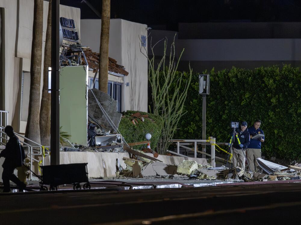 Investigators document the scene outside the damaged Palm Springs fertility clinic that was targeted in a bombing Saturday morning.