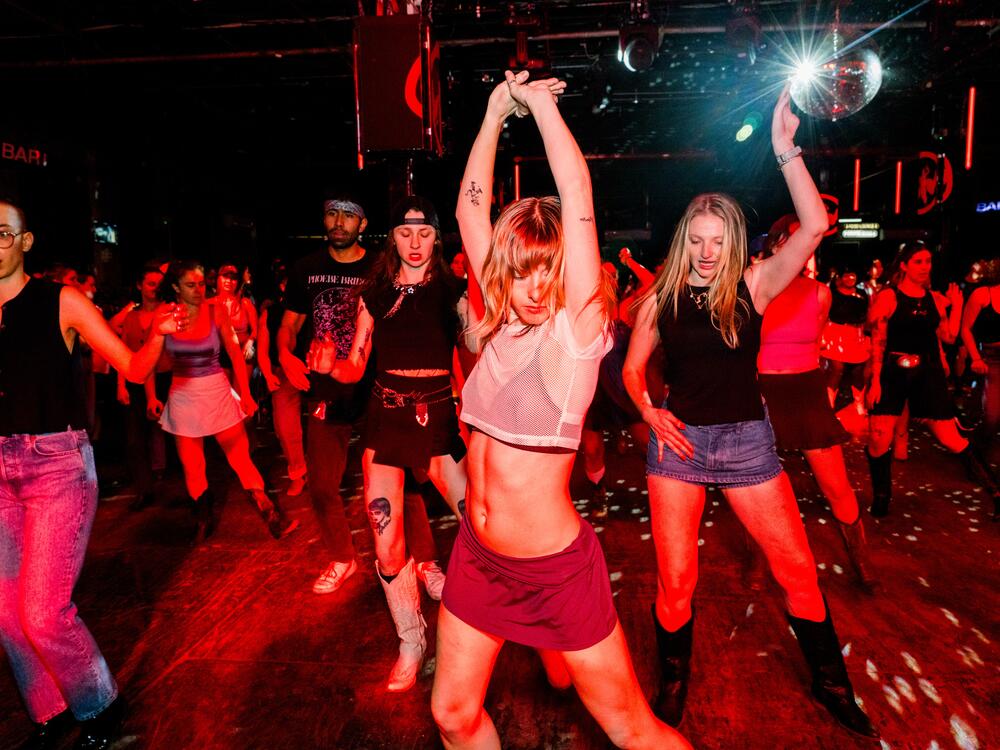 Kitty Horblit (left), Karli Manship (center) and Hannah Bruns (right) line dance at a Stud Country event on March 25, 2025, in Brooklyn, New York.