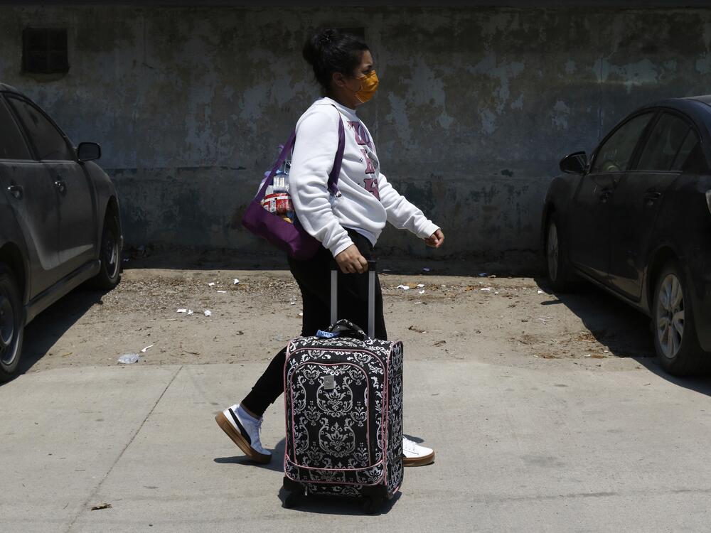 A Honduran migrant who returned voluntarily from the United States walks after arriving at Ramon Villeda Morales Airport in San Pedro Sula, Honduras on Monday.
