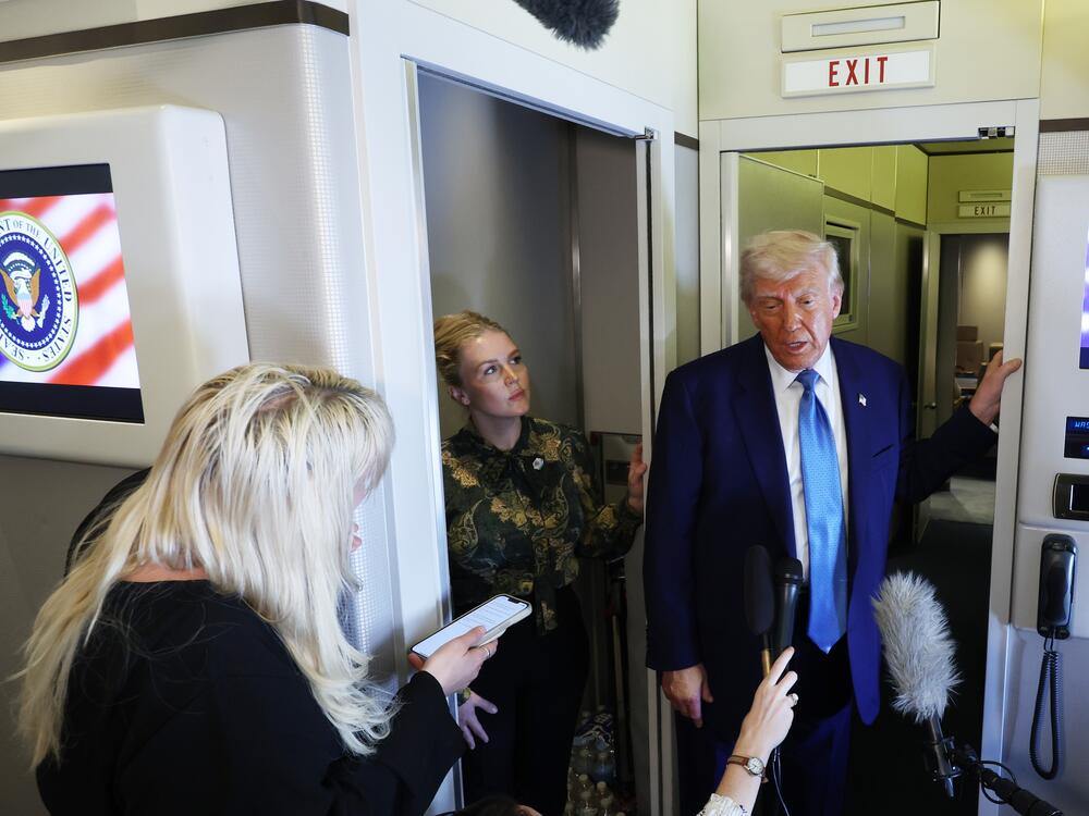 President Trump speaks to reporters in the press cabin of Air Force One as he departs Abu Dhabi, United Arab Emirates, on May 16, 2025.