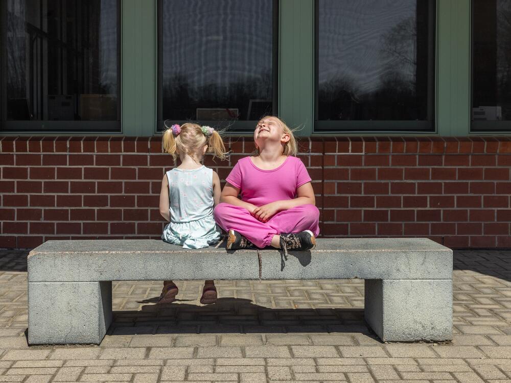 Second grader Mia Martin (right) shares a moment outside of school with younger sister Sophia Martin, who is not yet school age.