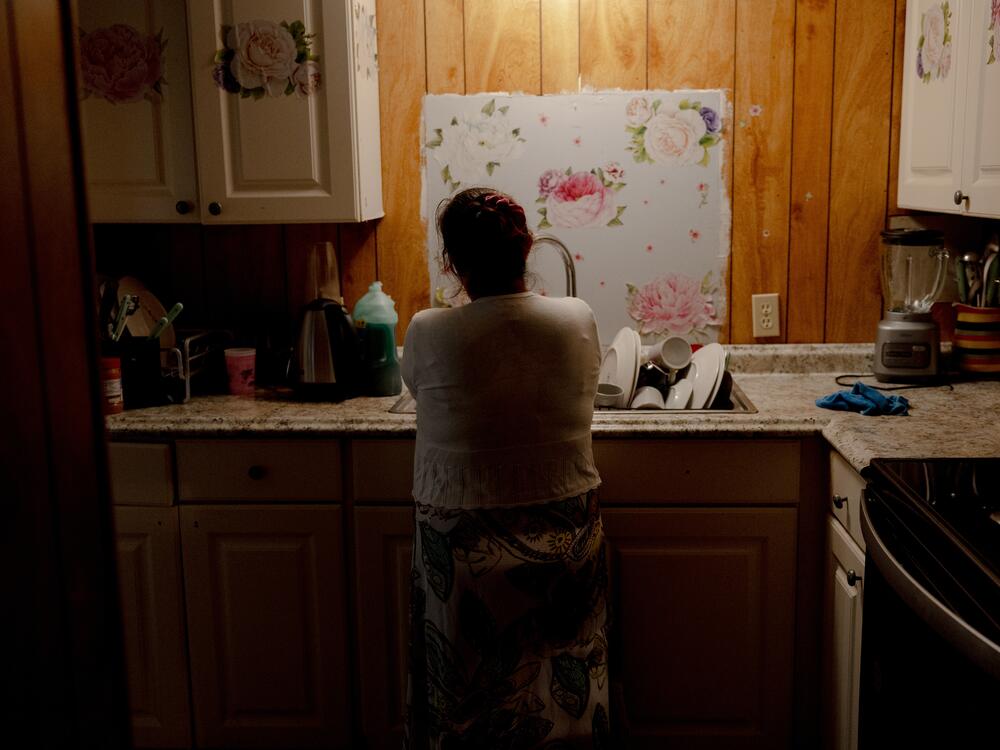 Marleny washes the dishes in her home, Saturday, May 10, 2025, in Tampa, Florida.