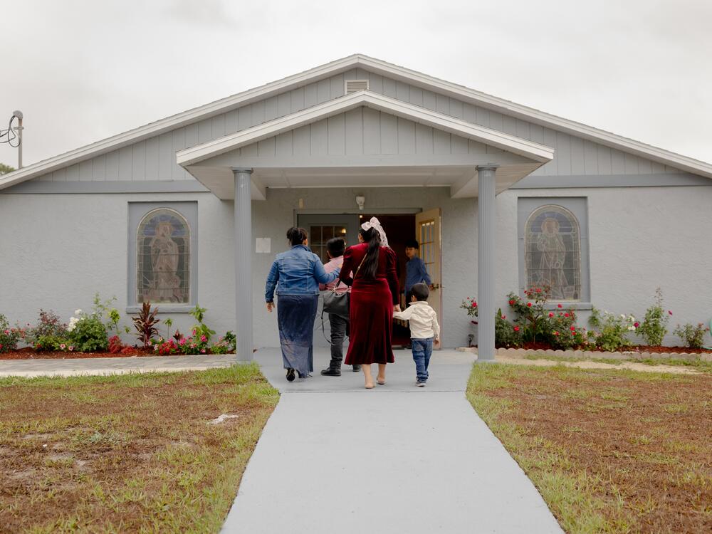 Churchgoers, the majority from Central America, walk into the Evangelical church that the Ambrosia Gonzalez family run, Sunday, May 11, 2025, in Tampa, Florida.