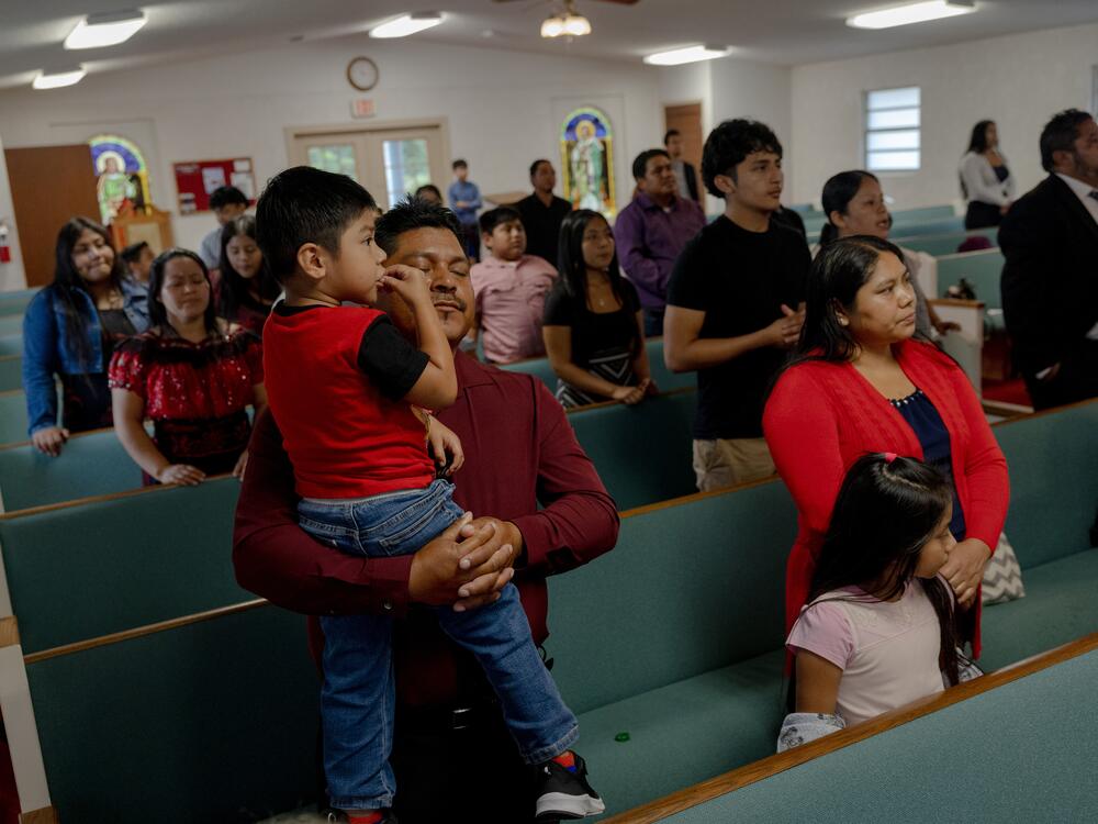 Churchgoers pray during service at the Evangelical church Sunday, May 11, 2025, in Tampa, Florida. The service focused on celebrating the mothers in attendance, as well as Maurilio Ambrocio's continued detention in an immigration facility.
