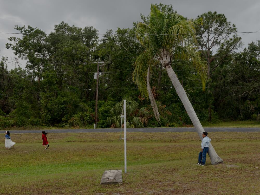 Children run through the field after church service lets out, Sunday, May 11, 2025, in Tampa, Florida.