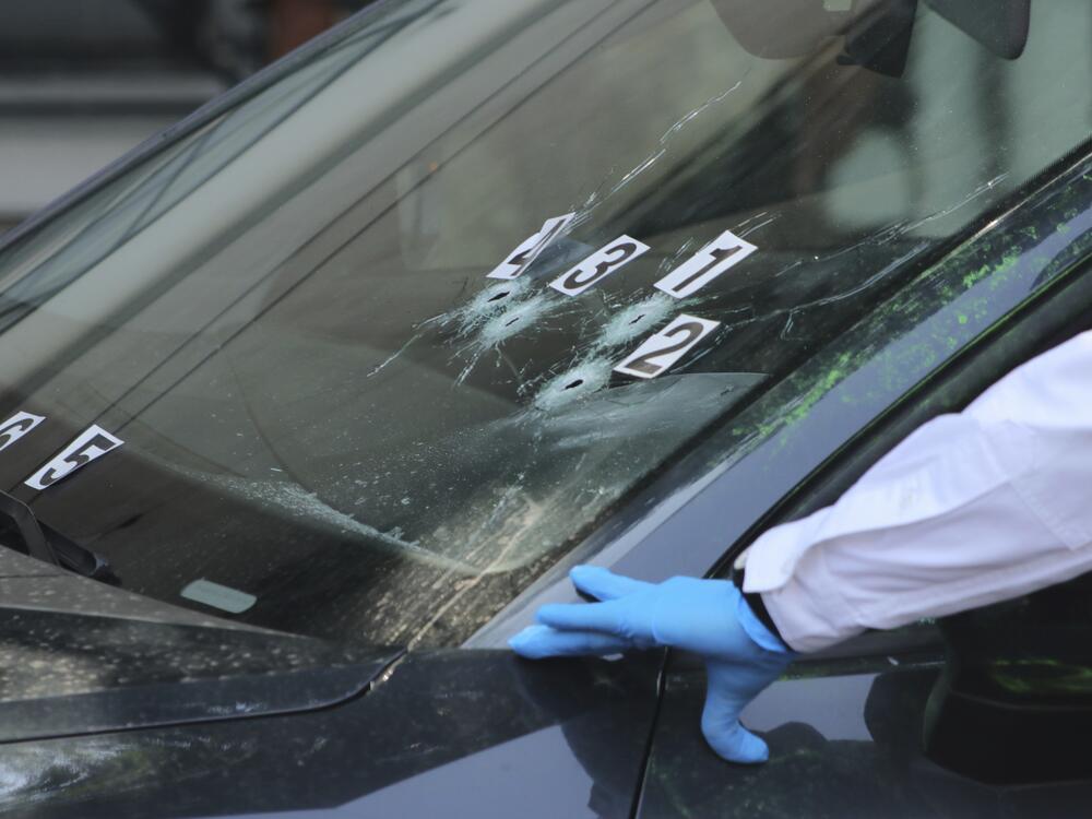 Crime scene investigators work at the site where the personal secretary and an advisor to Mexico City's mayor were killed by gunmen on a motorcycle, in Mexico City, Tuesday, May 20, 2025. (AP Photo/Tristan Velazquez)