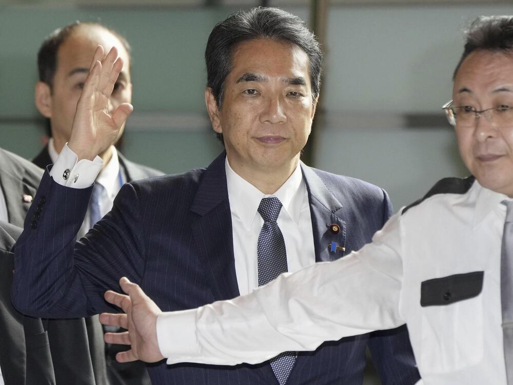 Japan's Agriculture Minister Taku Eto, center, arrives at the prime minister's office in Tokyo on Wednesday, May 21, 2025.