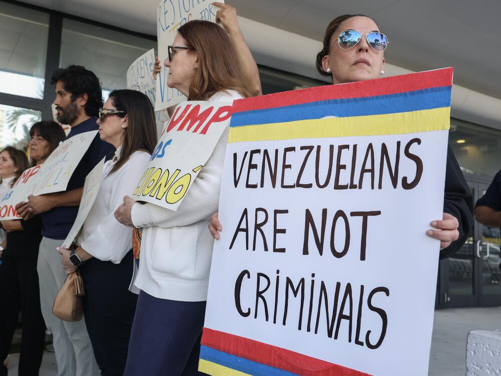 Maca Iglesias (R) joins with others to support a resolution in favor of reinstating temporary protected status for Venezuelans on February 13, 2025 in Miami, Fla. In early February, President Trump's administration revoked temporary protected status for around 350,000 Venezuelans who fled the country and immigrated to the United States.