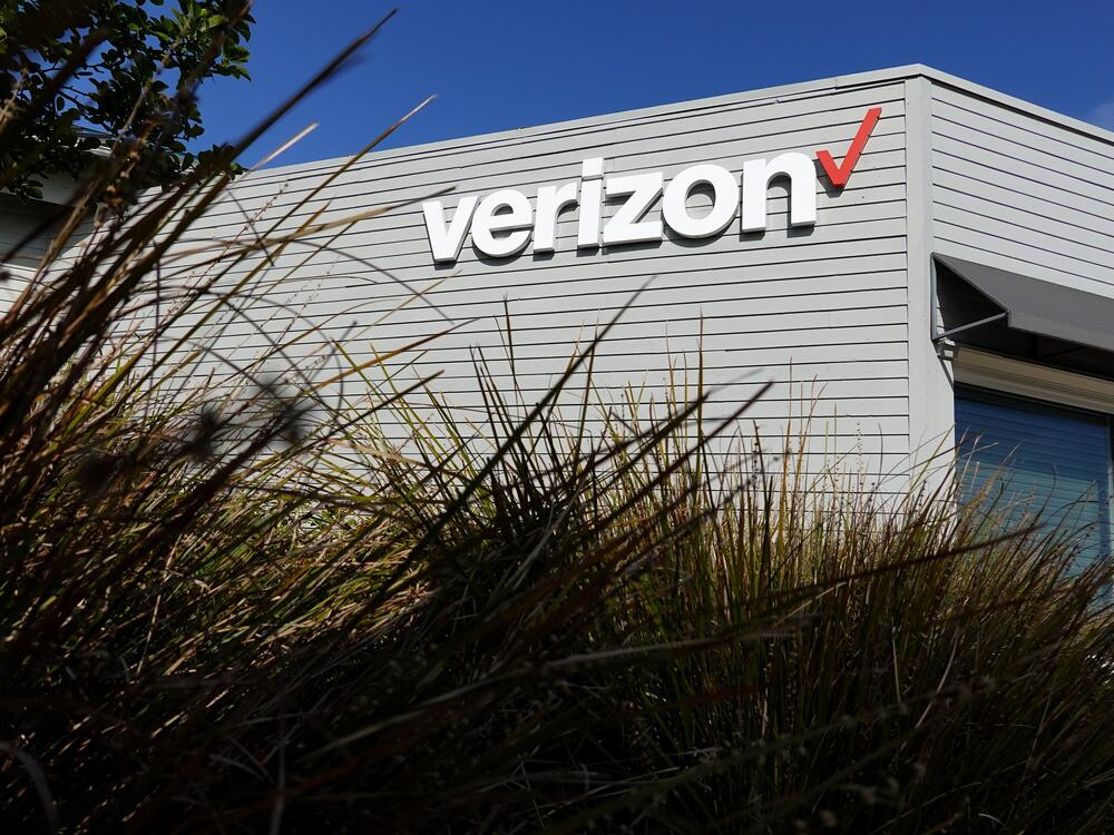 The Verizon logo is displayed on the exterior of a Verizon store. The FCC approved its $20 billion deal to buy Frontier Communications, a day after Verizon told the U.S. regulator that it would end many of its diversity-related policies.