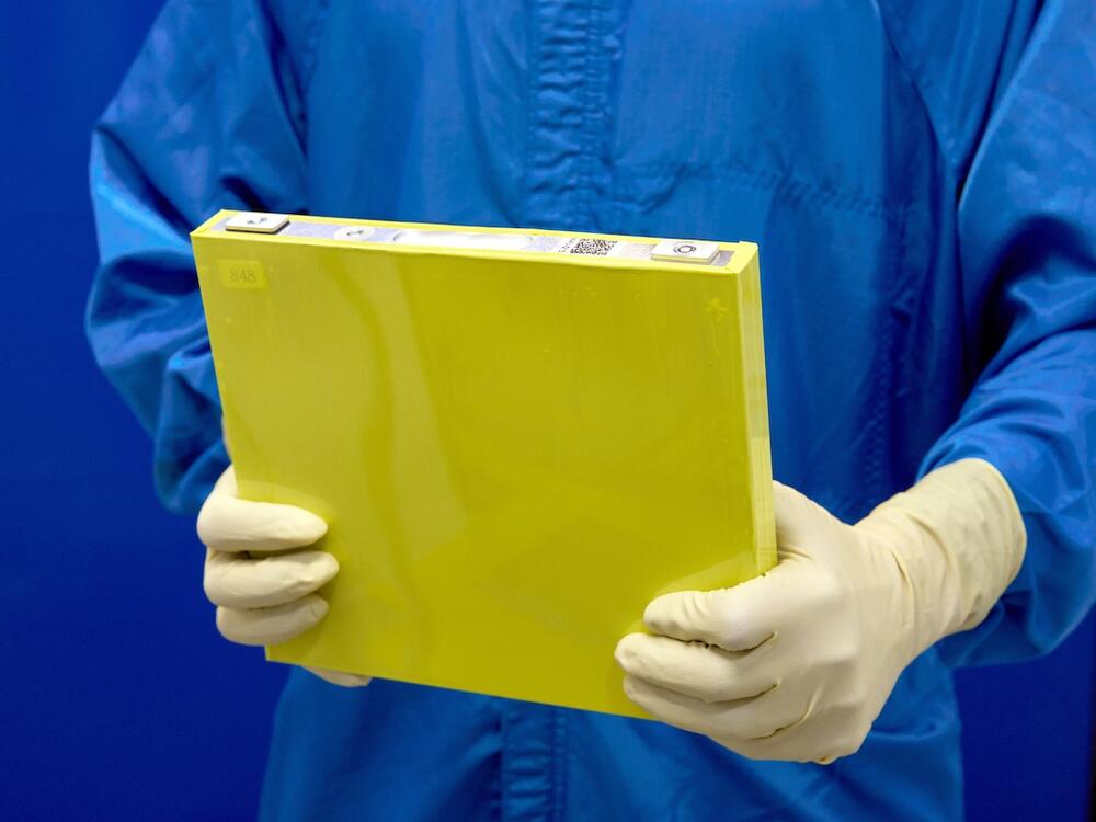 An employee holds a full-size prototype LMR battery cell at the General Motors Wallace Battery Cell Innovation Center. GM has prototyped approximately 300 full-size LMR cells as it worked with LG Energy Solution to crack the code on the chemistry.