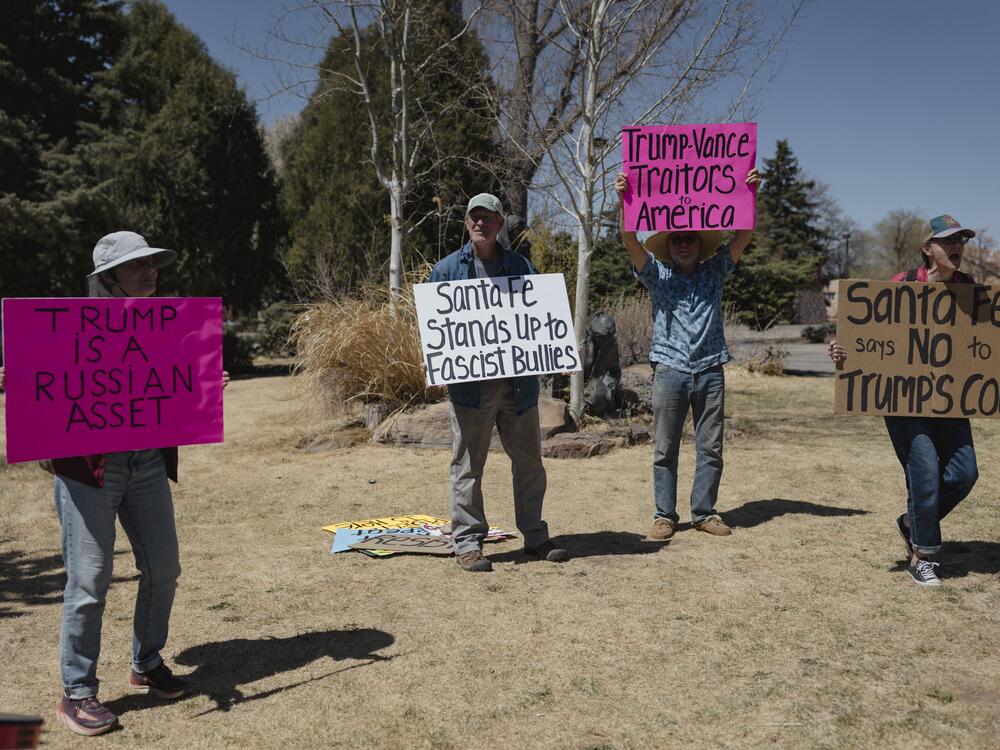 Protesters (left to right) Celia Hulton, David Receconi, Richard Folks and Carol Norris demonstrate outside the New Mexico State Capitol in Santa Fe on April 9. Norris founded the protest group, Resist-Rest-Repeat, two months ago.