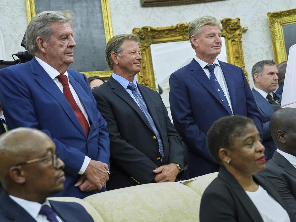 Standing from left, South African businessman Johann Rupert and golfers Retief Goosen and Ernie Els look on as President Trump meets South African President Cyril Ramaphosa in the Oval Office of the White House on Wednesday.