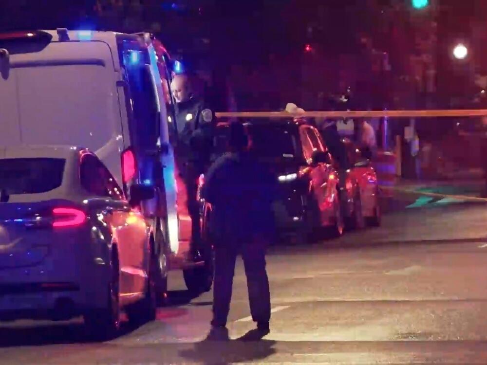 In this image taken from video provided by WJLA, a spectator watches as law enforcement works the scene after two staff members of the Israeli embassy in Washington were shot and killed outside the Capital Jewish Museum on Wednesday, May 21, 2025, in Washington, D.C.