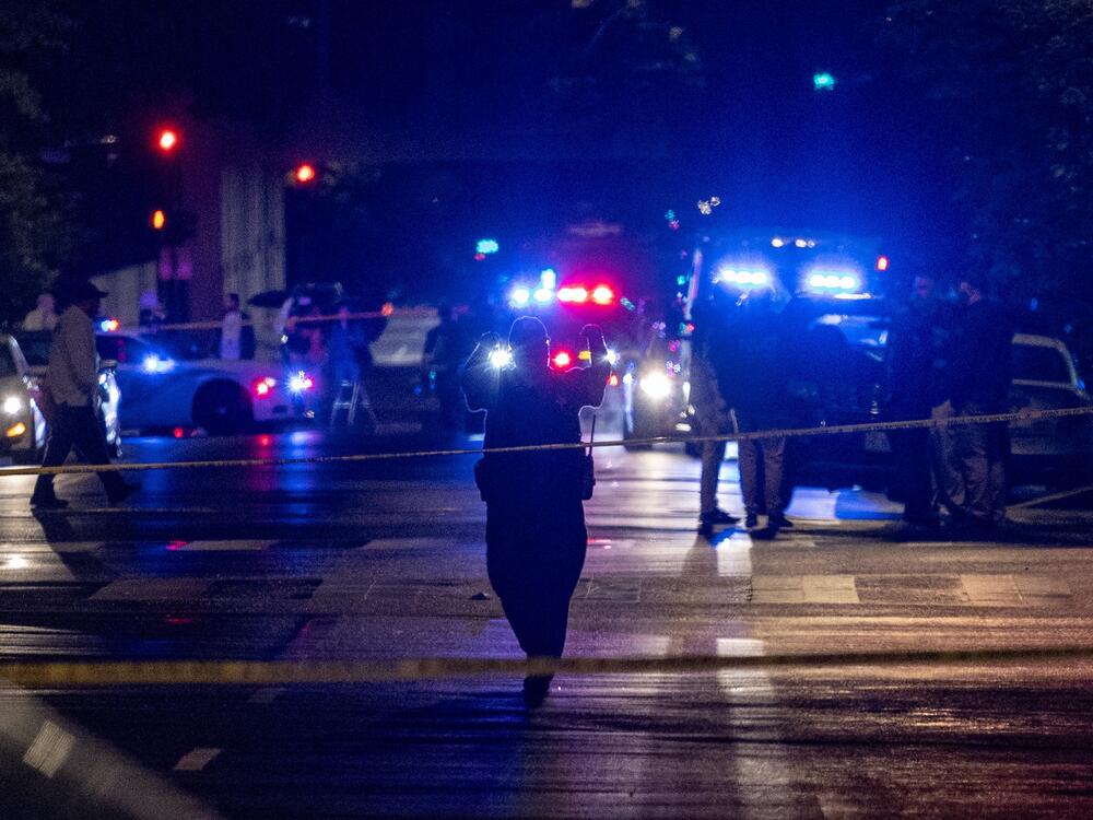 FBI agents and police officers work outside the Capital Jewish Museum in the early hours Thursday in Washington, D.C., following a shooting Wednesday night that left two people dead.