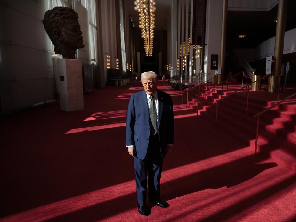 President Donald Trump talks to the media in the Hall of Nations during a tour at the John F. Kennedy Center for the Performing Arts after leading a board meeting on March 17, 2025.