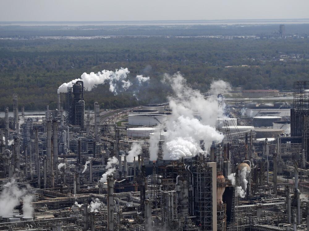 Wetlands are seen beyond a refinery in Norco, La.