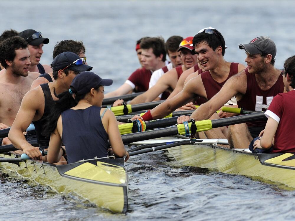 Members of Yale crew, left, and Harvard crew, right, greet one another after the 4-mile course along the Thames River for the 146th Harvard-Yale Regatta, in New London, Conn., on May 28, 2011.
