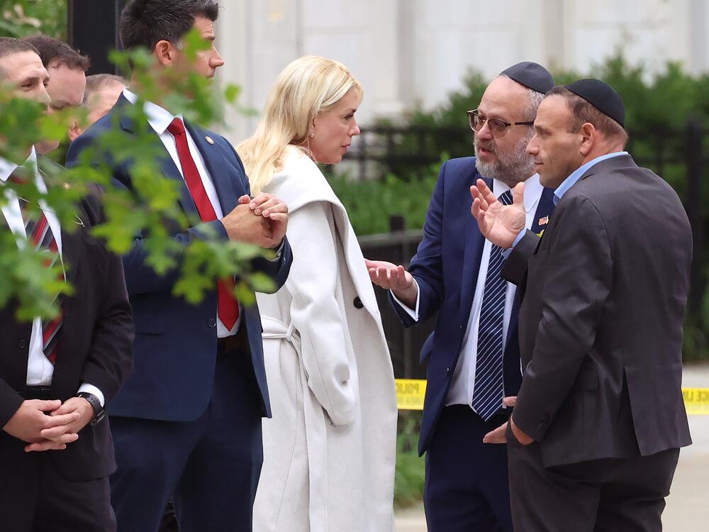 U.S. Attorney General Pam Bondi meets with officials as she visits the shooting site outside Lillian and Albert Small Capital Jewish Museum on Thursday in Washington, DC.