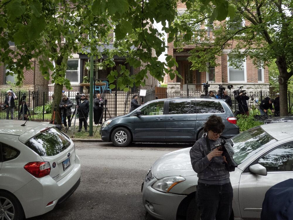 Journalists gather across trhe street from a building where shooting suspect Elias Rodriguez lived while law enforcement officials from the FBI, Joint Terrorism Task Force and Chicago Police participate in a search of his residence on Thursday in Chicago, Illinois.