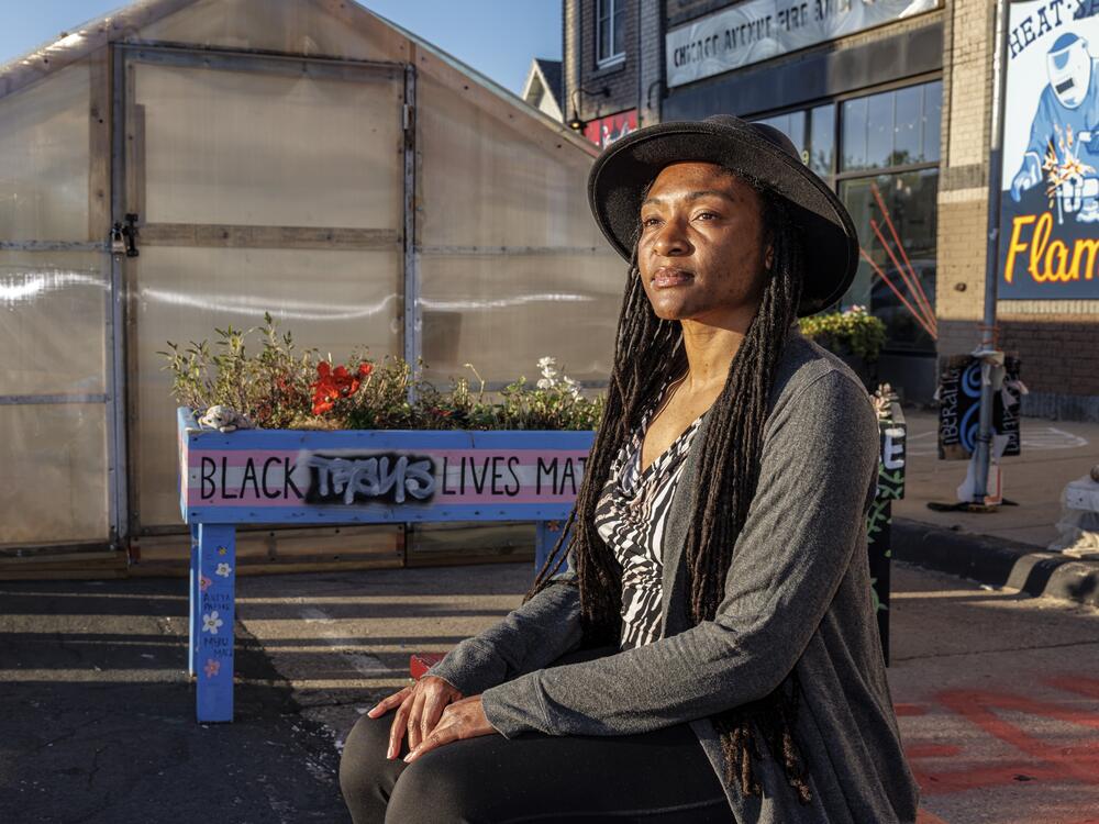 Jeanelle Austin, who leads the racial justice group Rise and Remember, sits outside the greenhouse set up at George Floyd Square.