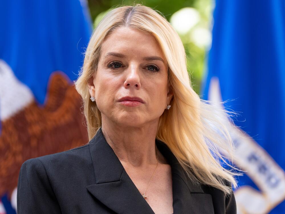 Attorney General Pam Bondi listens during a news conference at the Department of Justice on May 7, 2025 in Washington. In late April, the DOJ's Office of Justice Programs cancelled hundreds of public safety grants to local police and nonprofits, leaving many scrambling.