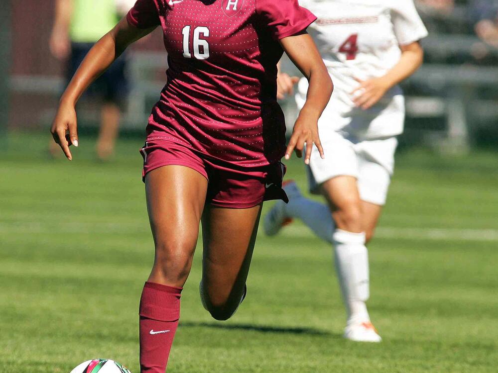 Harvard's Margaret Purce, left, kicks the ball past Massachusetts' Rebekka Sverrisdottir in the first half of an NCAA college soccer game on Sept. 20, 2015, in Amherst, Mass.